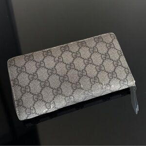 Gucci zip around long wallet in the classic GG Supreme canvas.